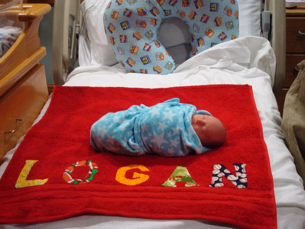 Logan on his name towel